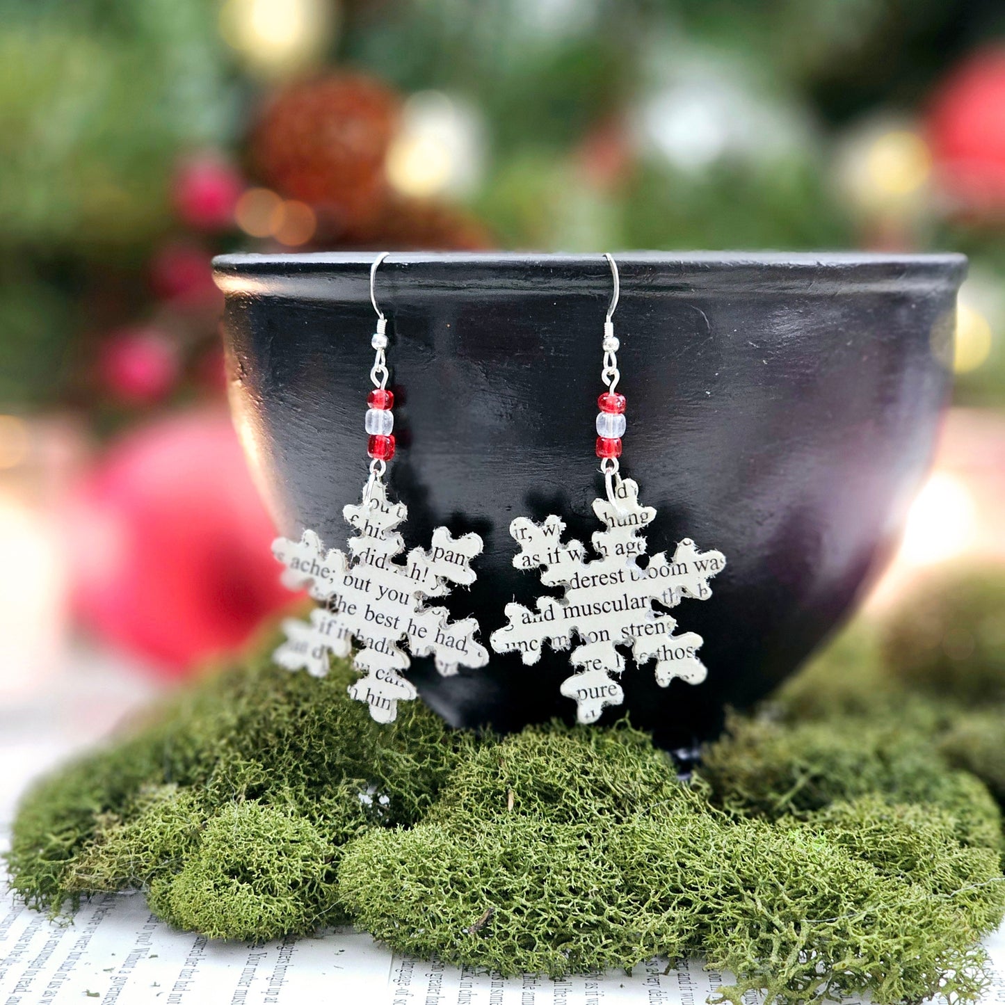 Snowflake Dangle Earrings made from upcycled book pages. Each earringhas 3 glass seed beads at the top. Sterling silver earwire.