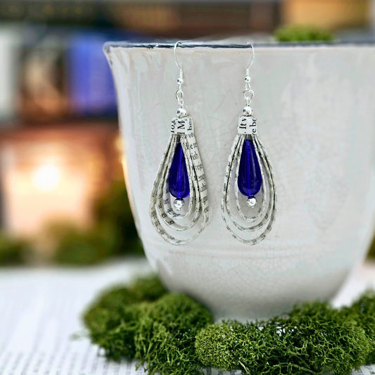 Tear Drop dangle earrings made from upcycled book pages with a blue czech glass tear drop bead accent.  earring is 2.5 inches long.  Sterling silver ear wire.