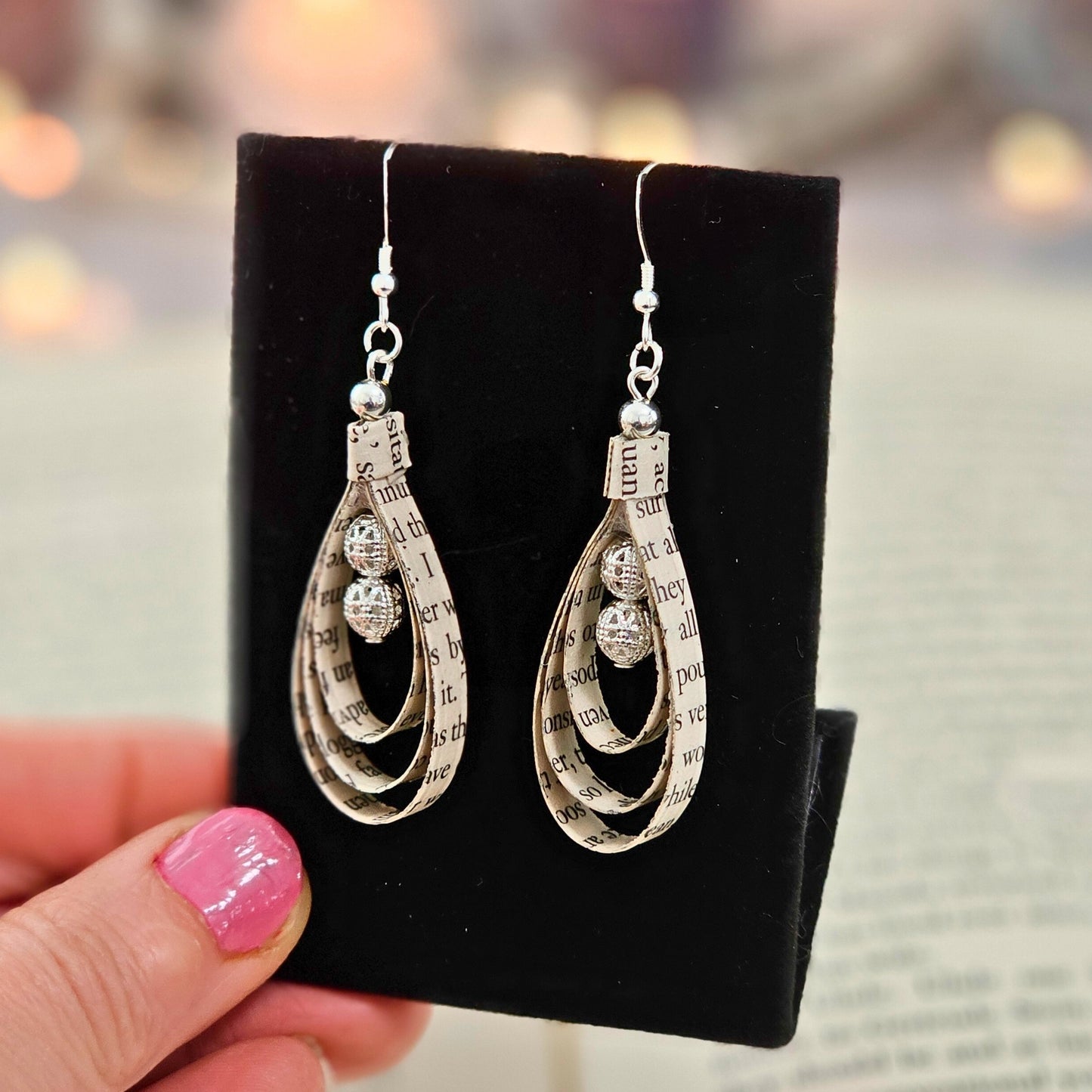Tear drop shaped book page ornaments. Made from upcyceld book pages taken from literary classes. Sterling Silver Ear wire. Center of tear drop has two silver plated beads.