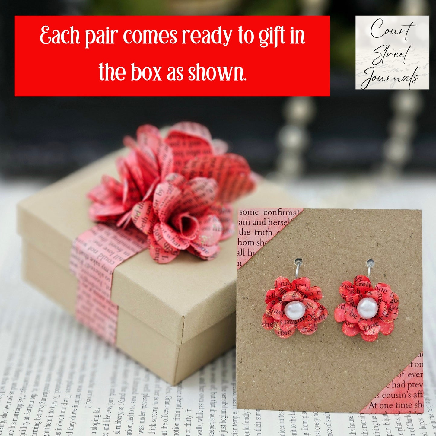 Red Rose Book Page Earrings, Drop Ear Wire made of stainless steel. The center of the rose has a whie acrylic accent. Each pair comes in a gift box adorned with 3 paper roses.