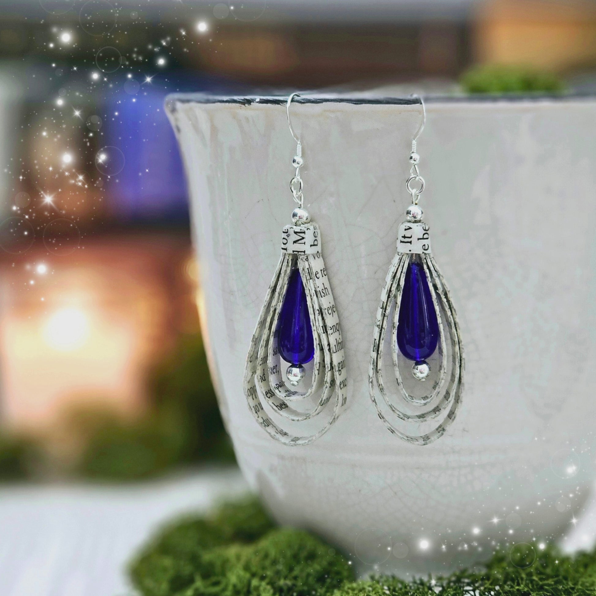 Tear Drop dangle earrings made from upcycled book pages with a blue czech glass tear drop bead accent.  earring is 2.5 inches long.  Sterling silver ear wire.