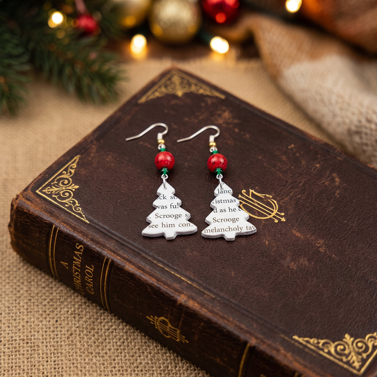 Close up shot of christmas carol tree earrings
