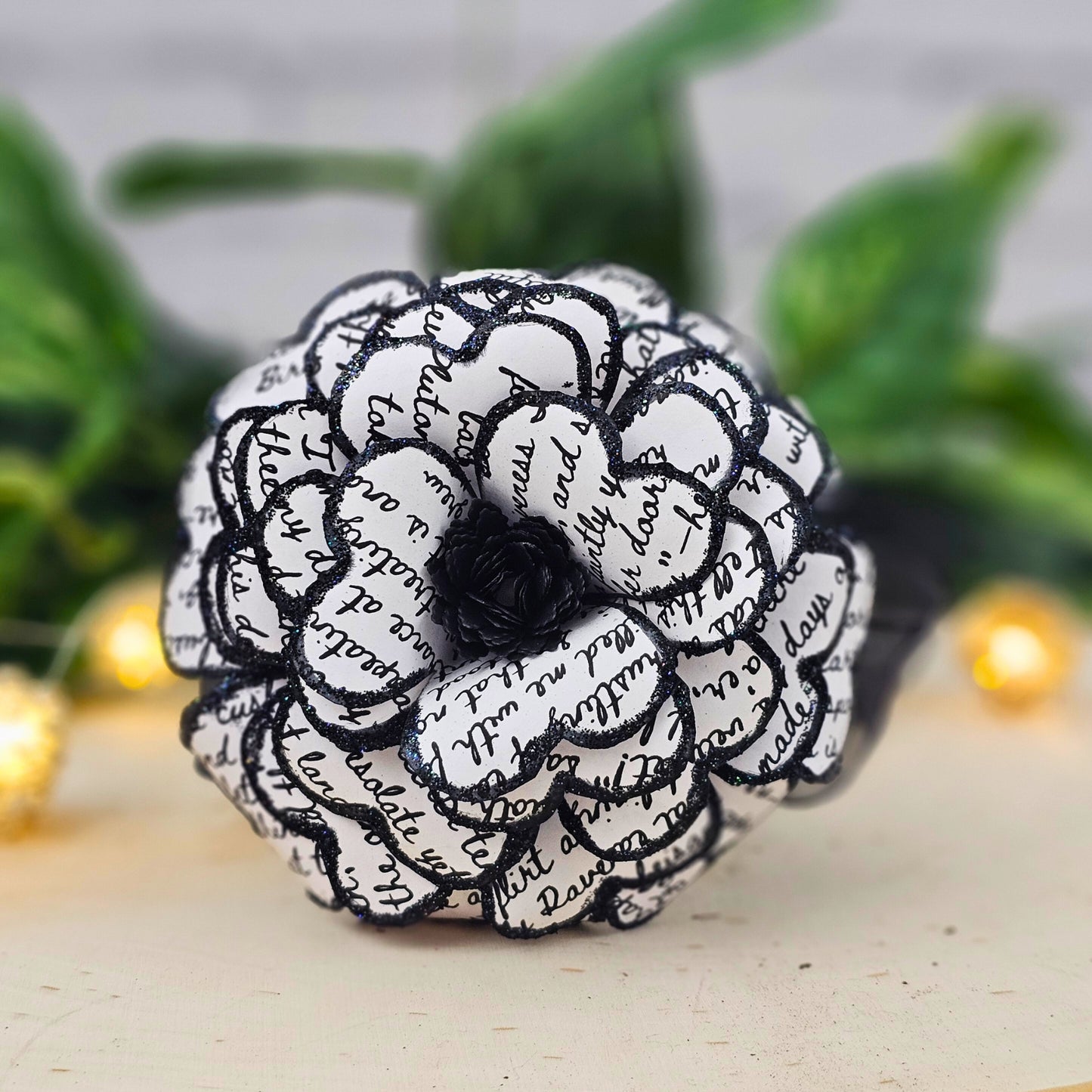 Close-up of gothic paper rose made from Edgar Allan Poe The Raven text