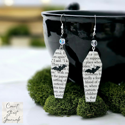 Coffin shaped book page earrings made from the pages of Dracula by Bram Stoker