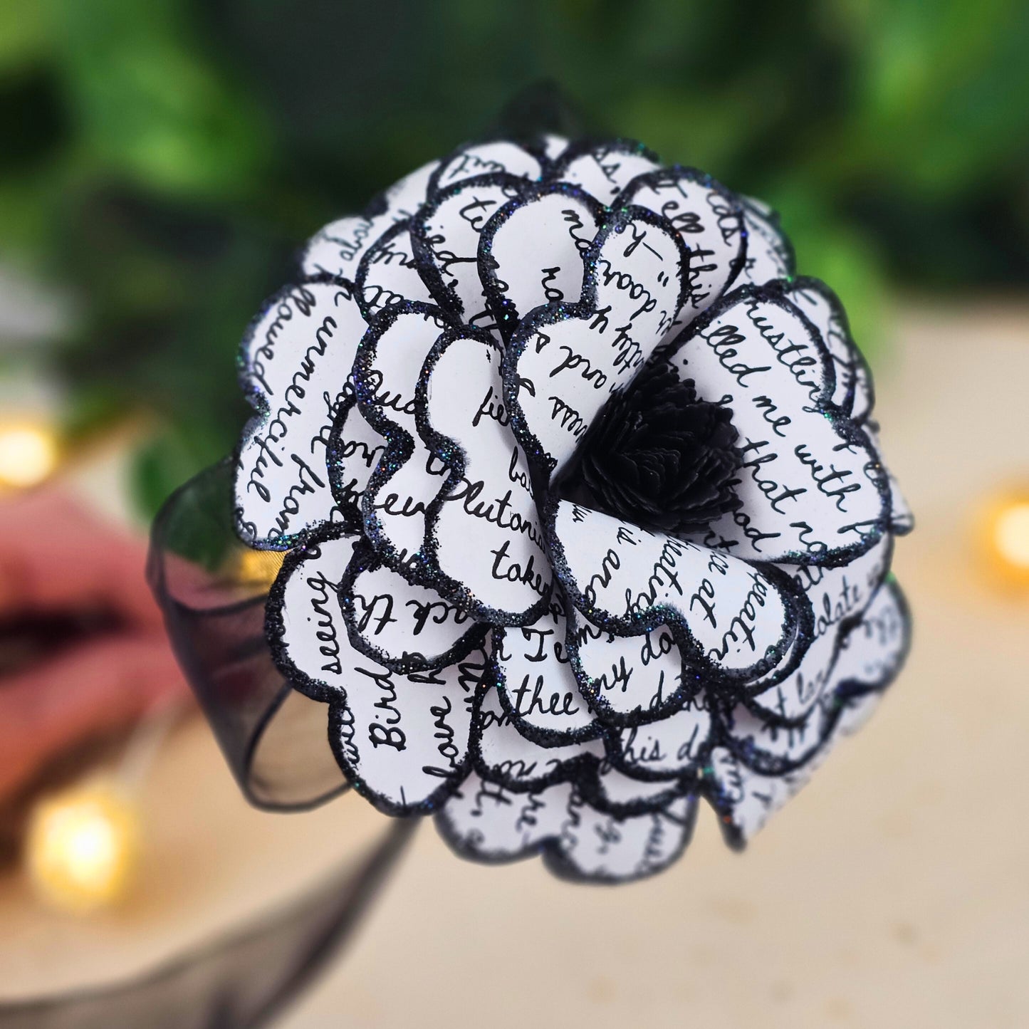 Close up view of center of flower; rolled black paper 