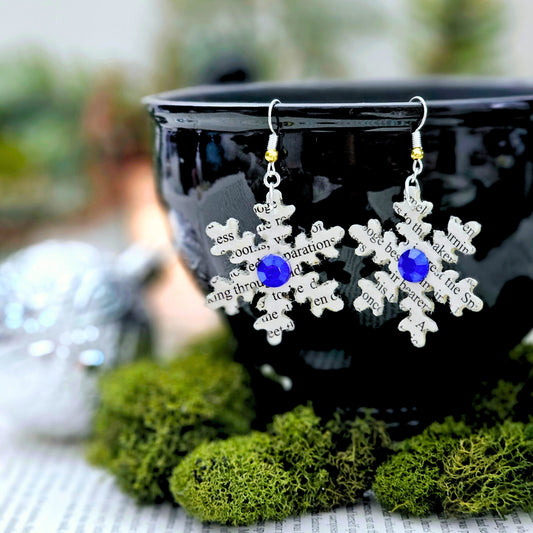 Snowflake book page earrings made from A Christmas Carol by Charles Dickens with blue accents