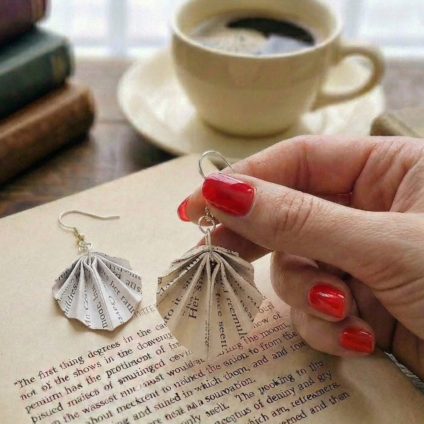 close up shot of origami book page fan earrings