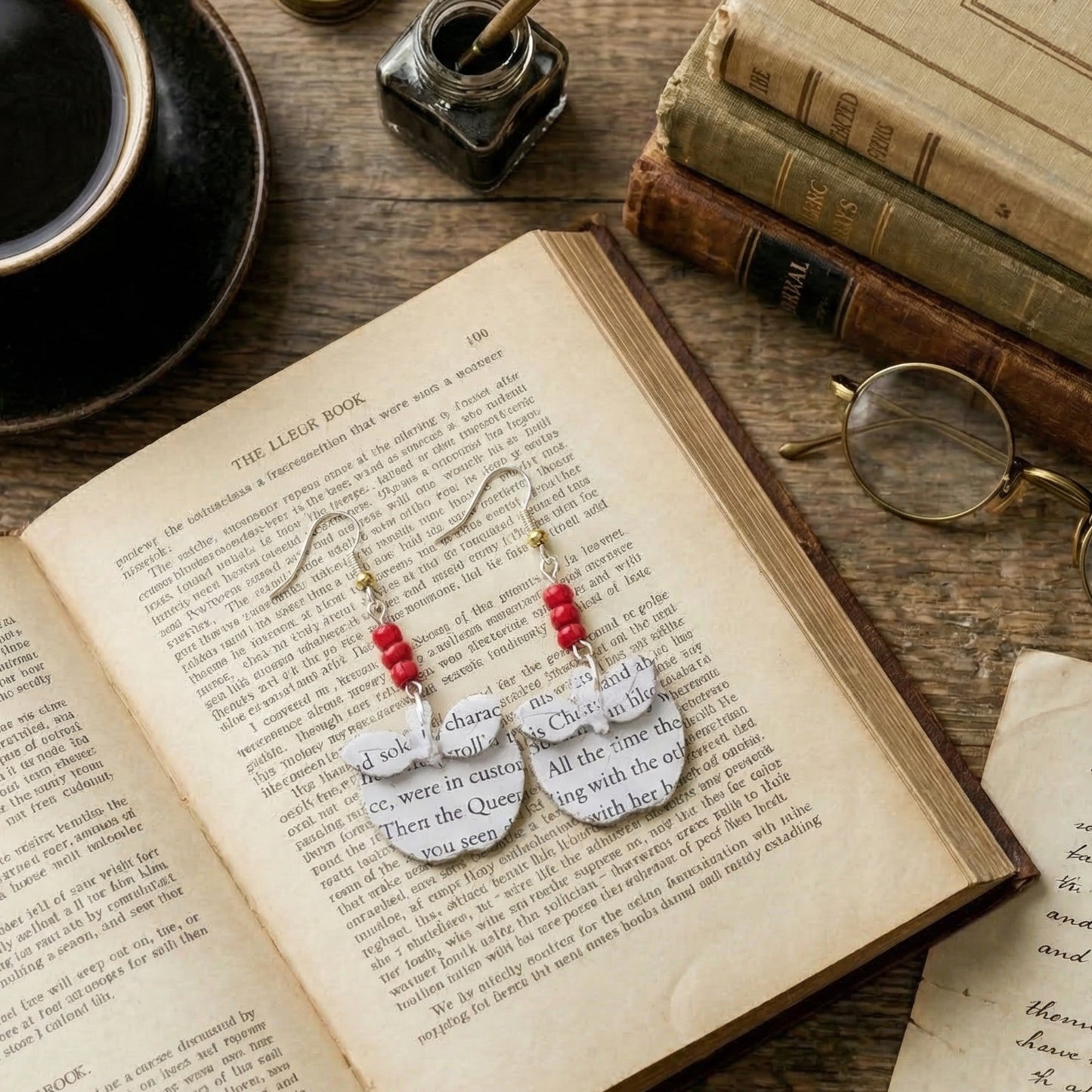 flat lay picture of apple book page earrings