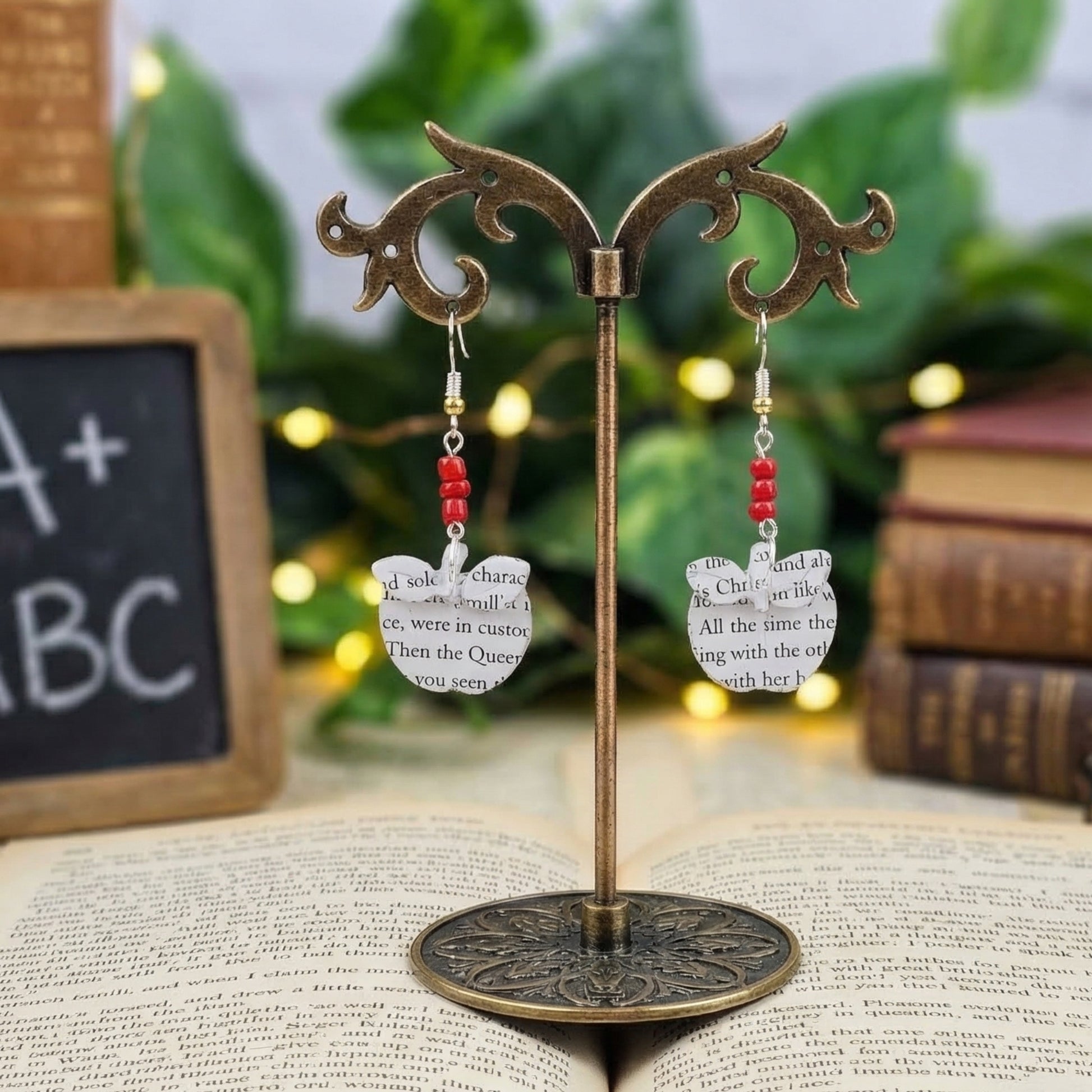 close up shot of apple book page earrings