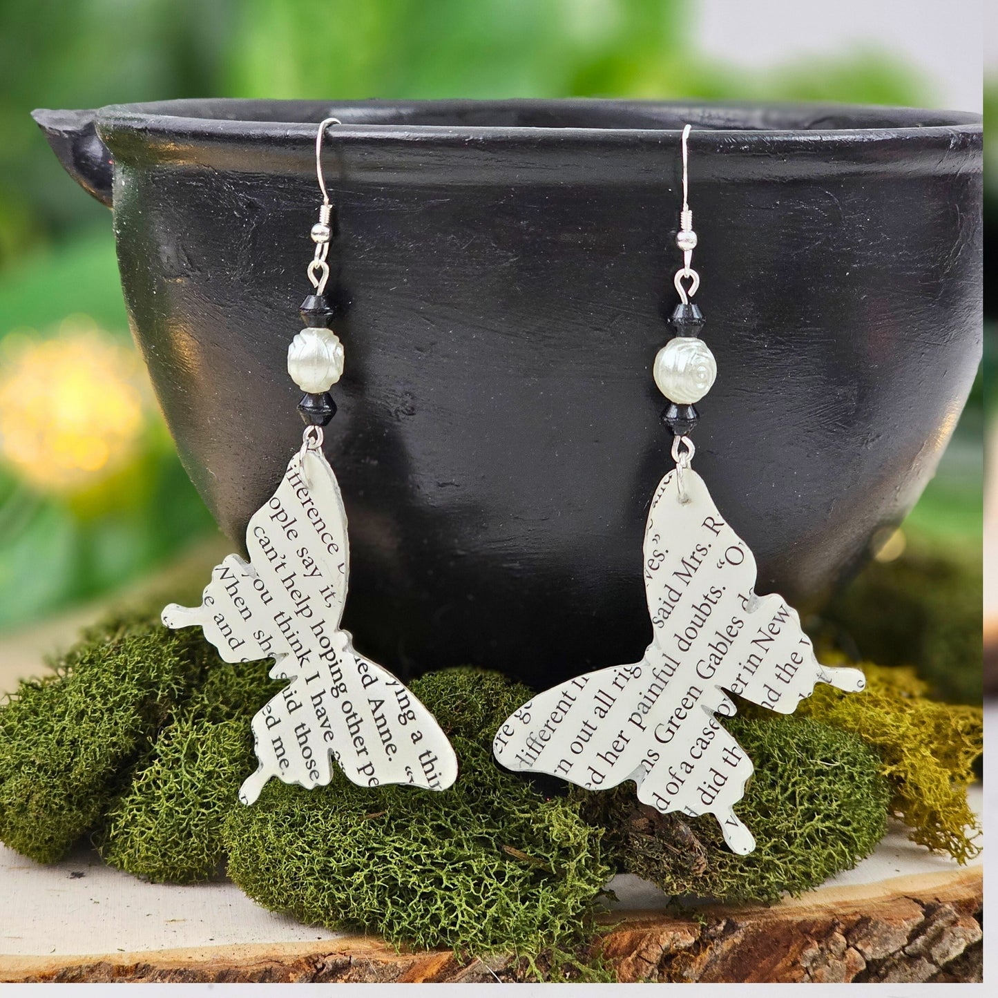 Close-up of water-resistant butterfly book page earrings showing durability