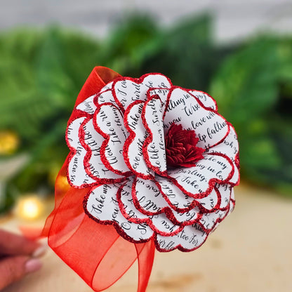 Close-up view of handmade red song lyric paper rose showing detailed petal texture