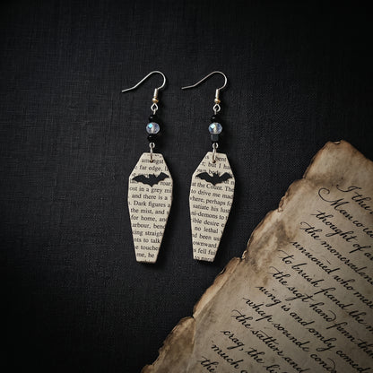 book page earrings made into coffins with a black bat