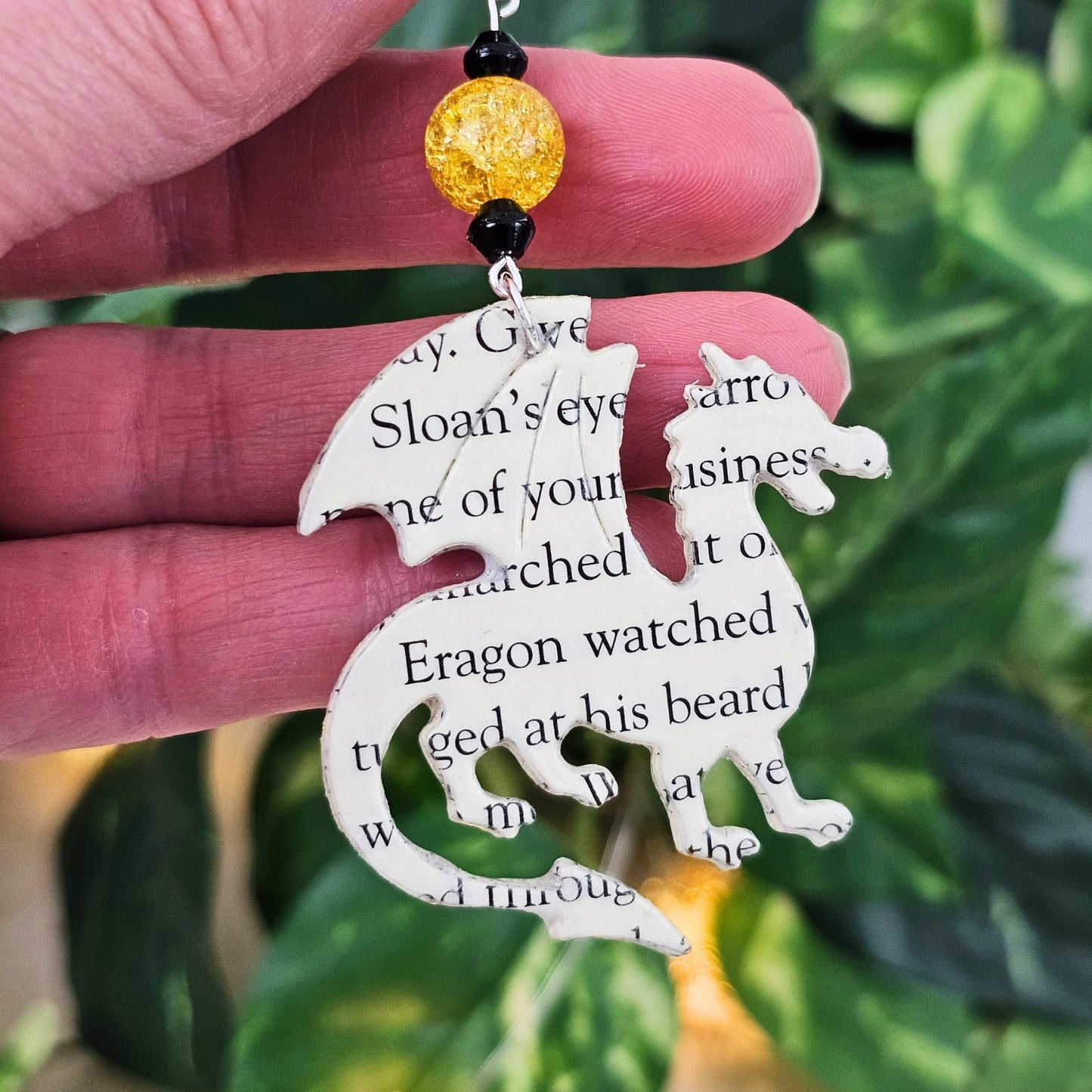 beaded accent on a dragon book page earrings