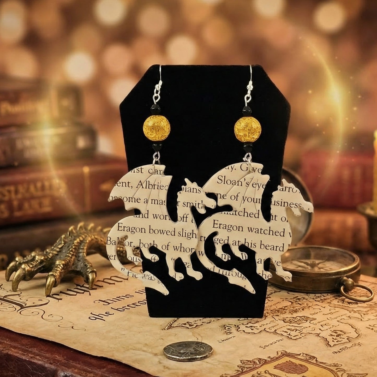 close up shot of dragon book page earrings