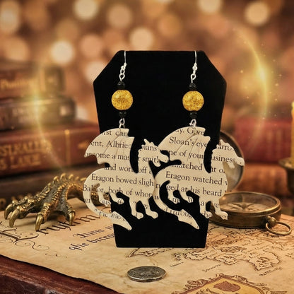 close up shot of dragon book page earrings
