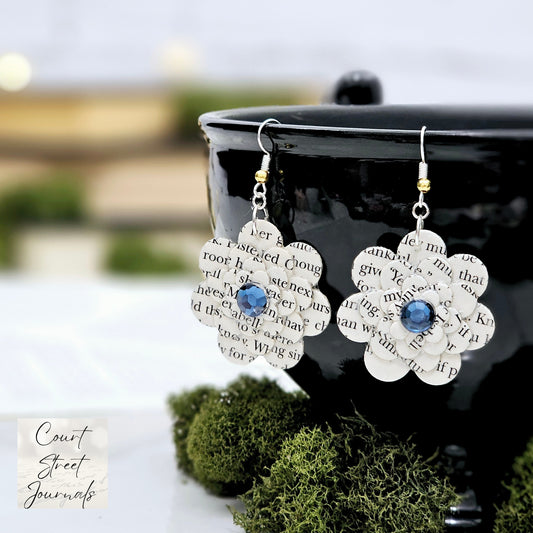 Flower dangle book page earrings with a blue acyrlic cabachon accent