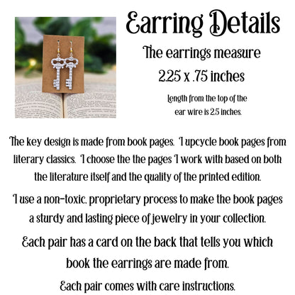 Earring details with key design made from book pages on an open book background