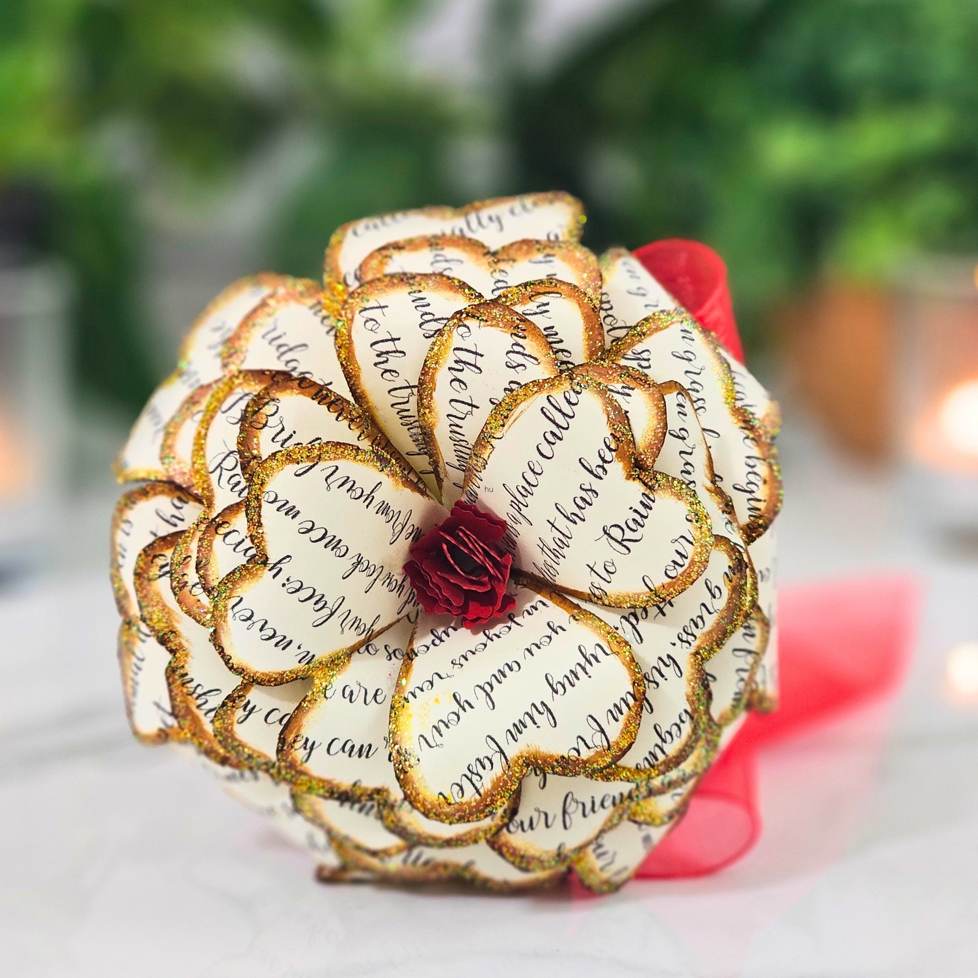 Close-up detail of handcrafted memorial rose made from upcycled book pages