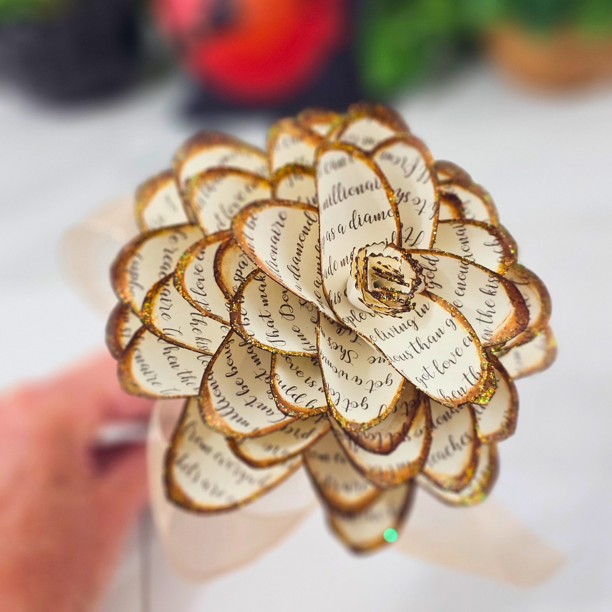 vintage style handmade paper dahlia flower with song lyrics printed on it