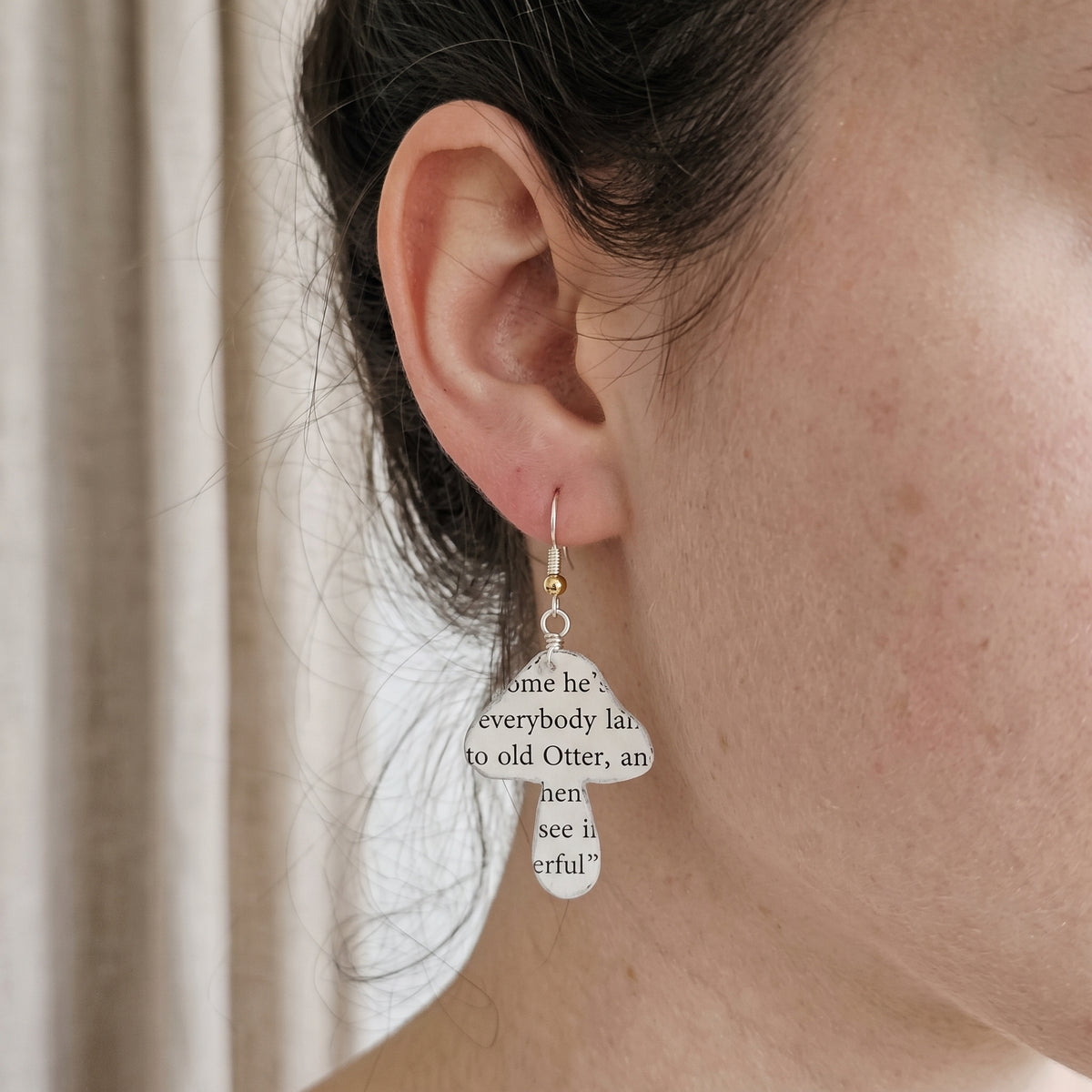 book page earrings in the shape of a mushroom
