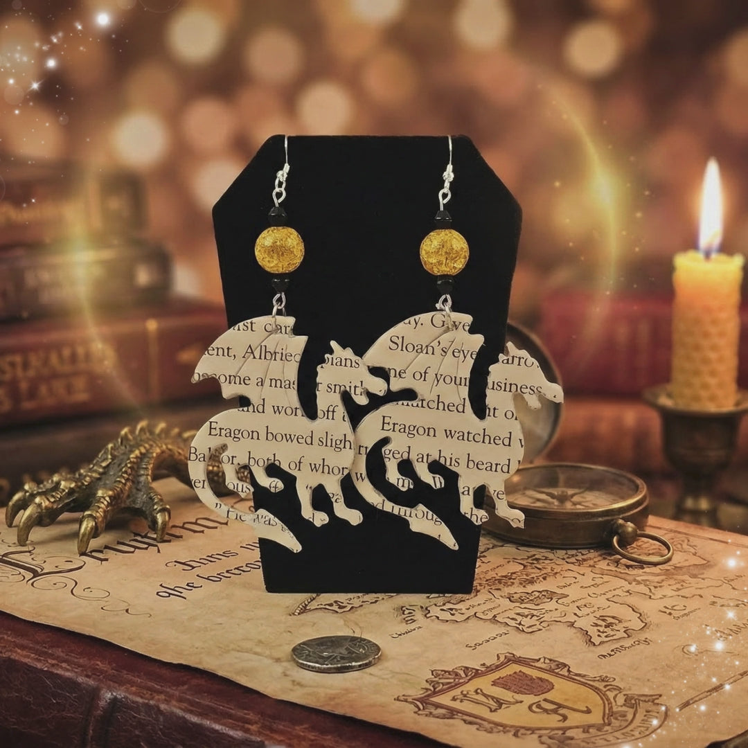 close up shot of dragon earrings made from books about dragons