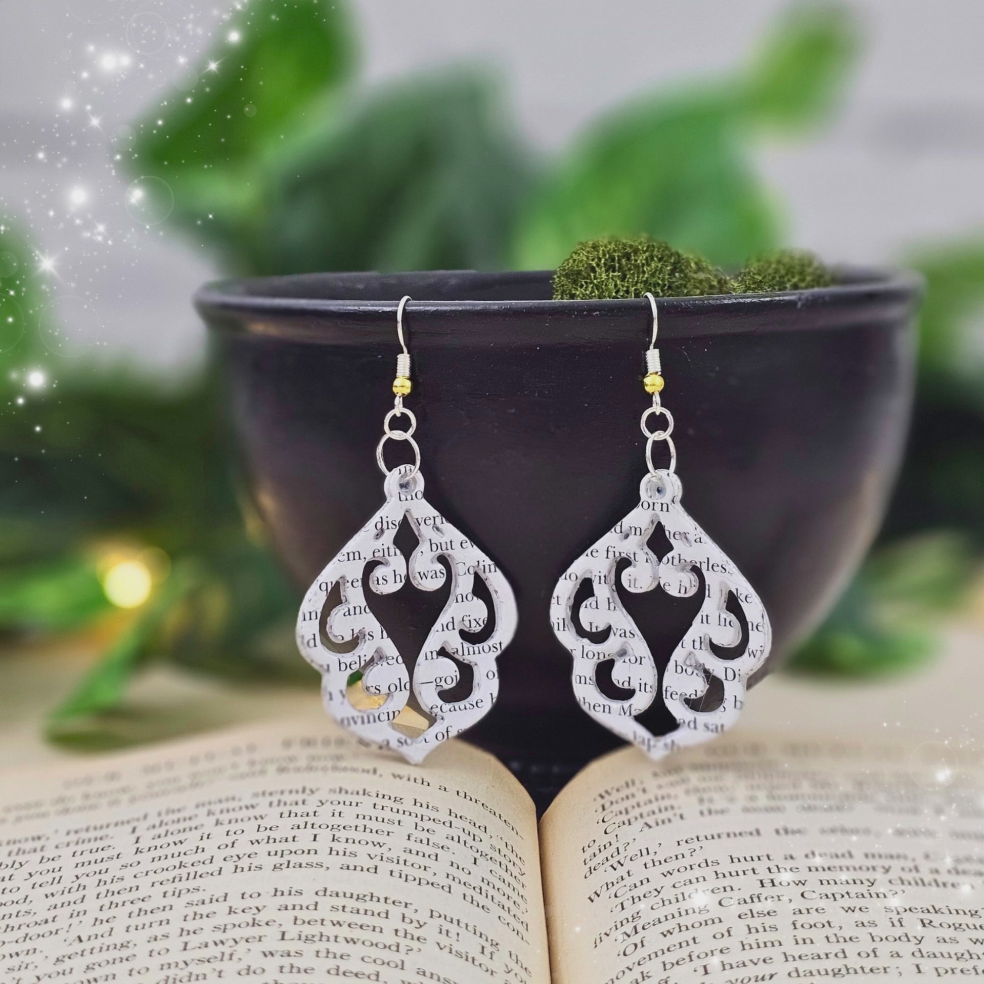 video of book page earrings in an elegant stencil cut design