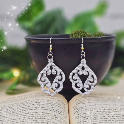video of book page earrings in an elegant stencil cut design