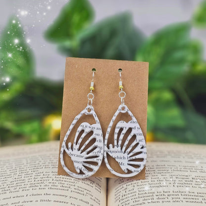 Close up of book page butterfly earrings perfect for book lovers
