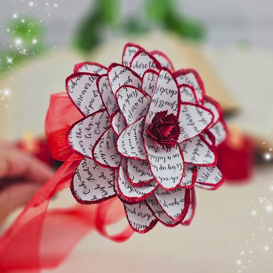 video of handmade paper dahlia made from acid free paper with sparkly red trim on each petal