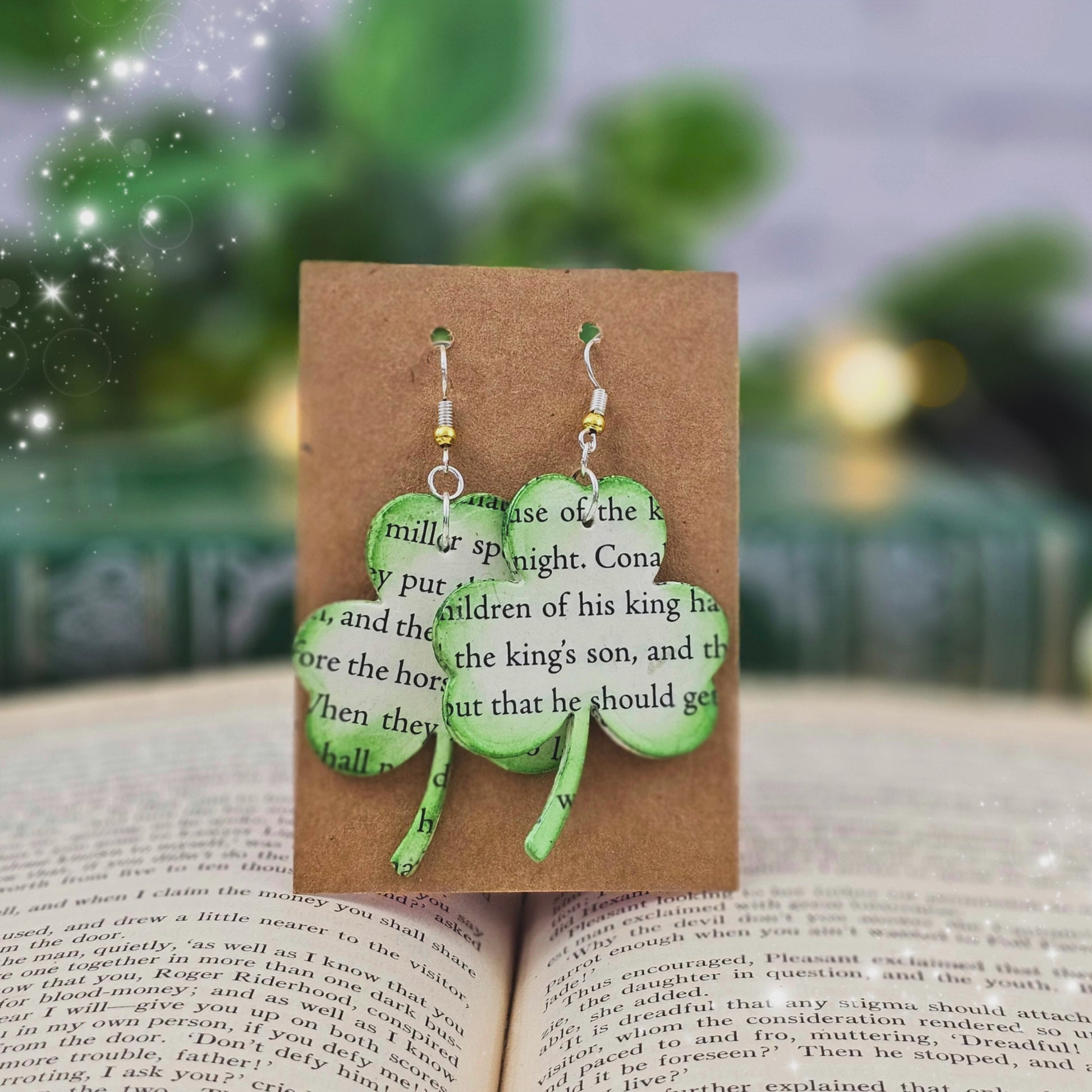 video of book lover earrings made in the shape of shamrocks, stained  green, made from irish folk tales