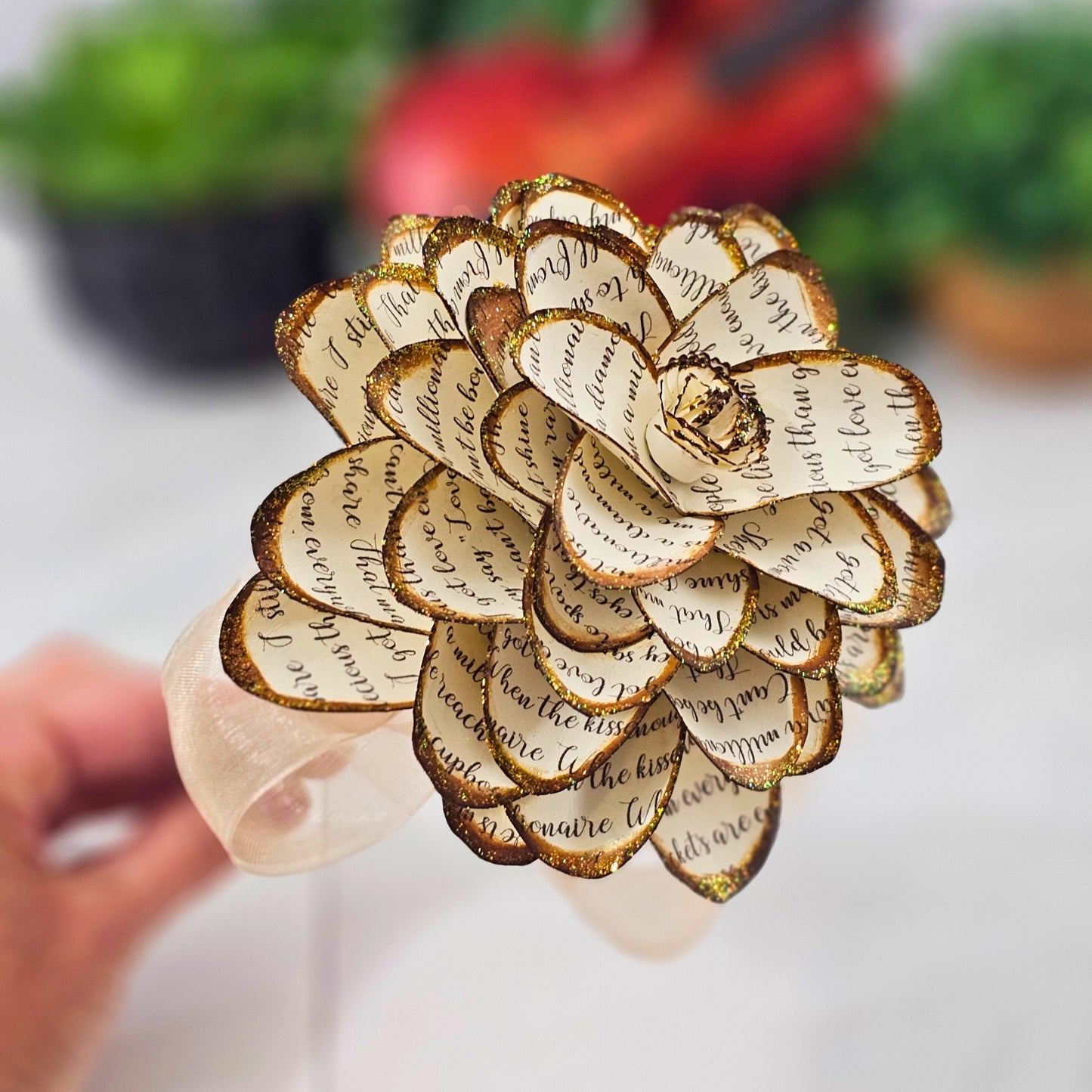 close up shot of petal details on a handcrafted paper dahlia made from song lyrics
