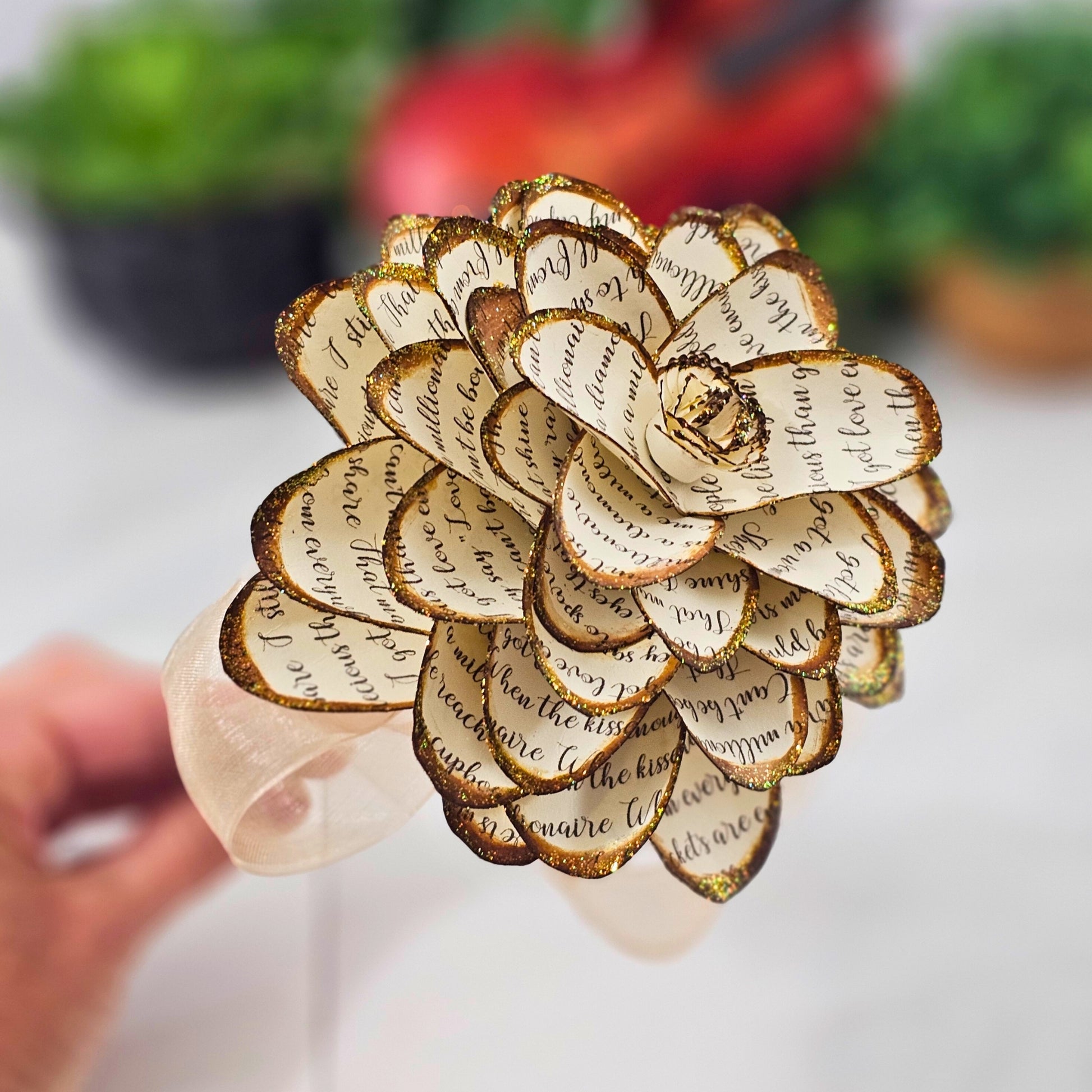 close up shot of petal details on a handcrafted paper dahlia made from song lyrics
