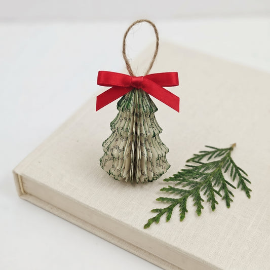 tiny book page christmas tree made from upcycled book pages with a jute string and red satin bow